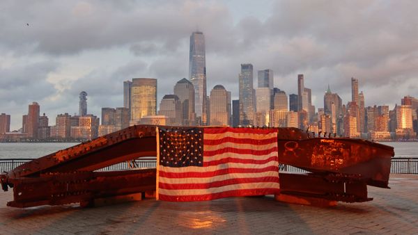 US flag on part of a 9/11 memorial overlooking the New York skyline from Exchange Place, Jersey City, New Jersey