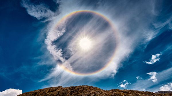 Sun halo over Lake Antermoia in the Dolomite Mountains of Italy