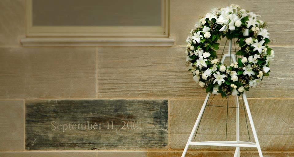 A wreath is placed next to a memorial stone, charred in the 9/11 attack, at the Pentagon in Washington, D.C.