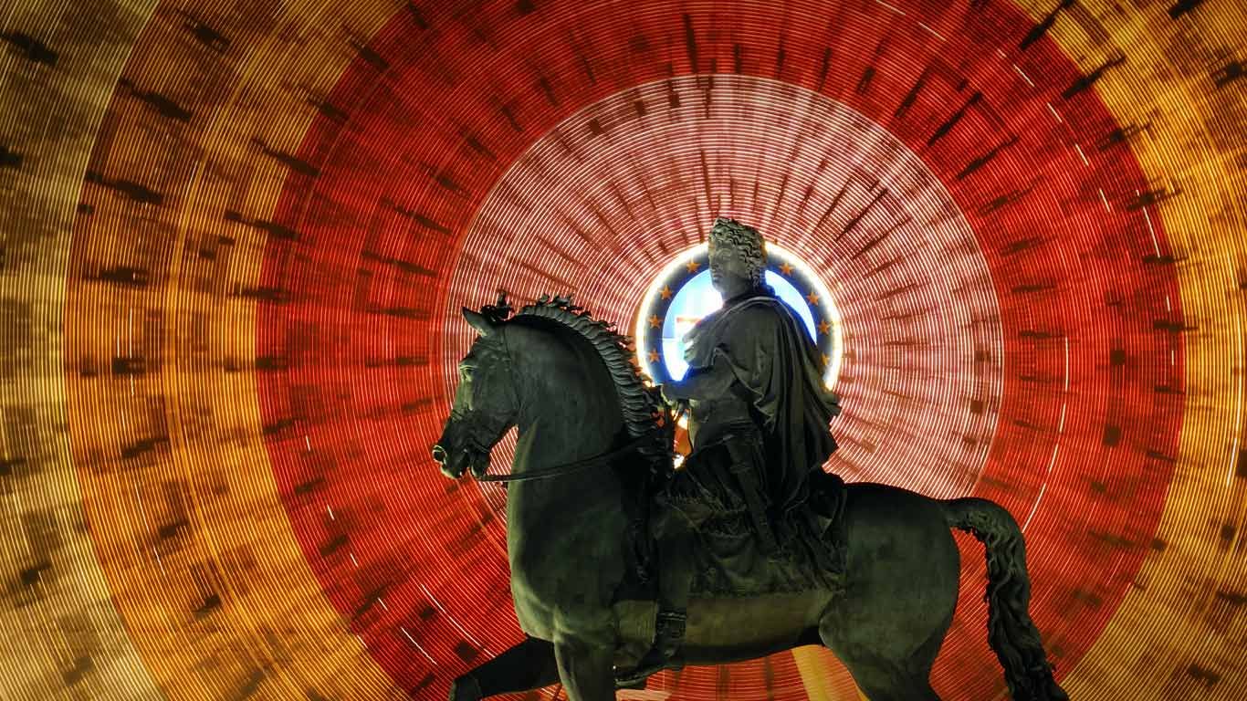 Louis XIV statue and spinning Ferris wheel at Place Bellecour in Lyon, France
