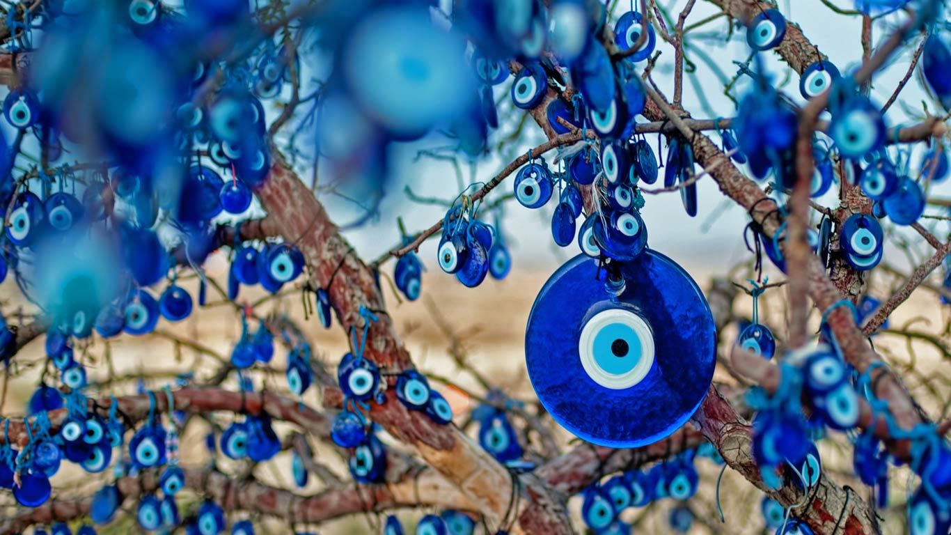 Tree decorated with amulets called nazars, Goreme National Park, Cappadocia, Turkey