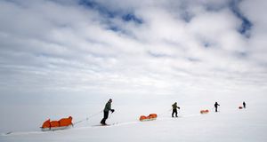 Skiers pulling sledges on route to South Pole, Antarctica -- Fiona McIntosh/Getty Images &copy; (Bing New Zealand)