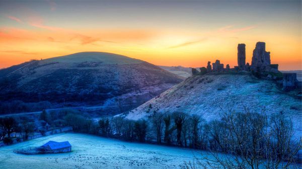 Colourful sunrise over Corfe Castle, Dorset, United Kingdom