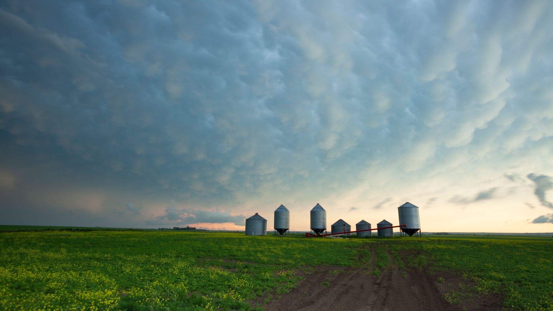 A prairie storm gathers over grain silos in Saskatchewan