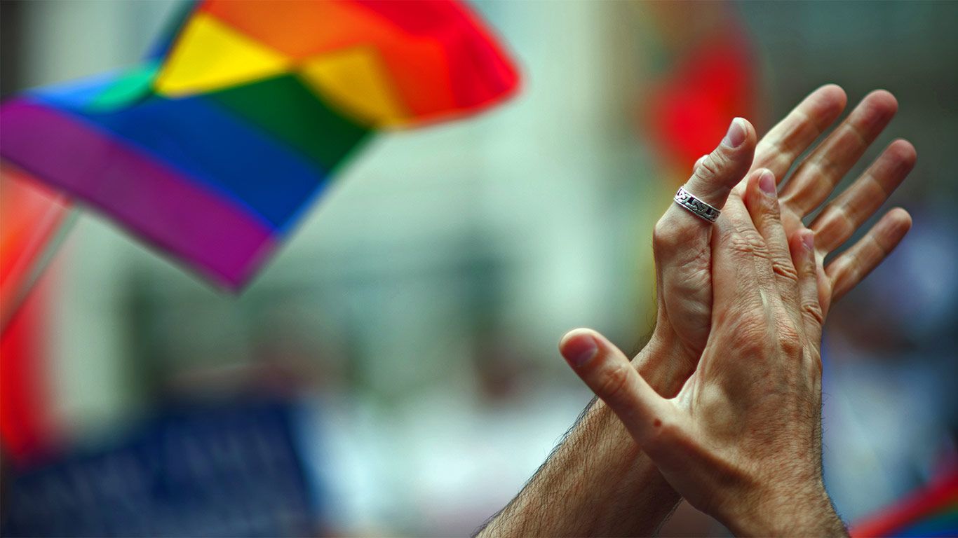 Rainbow flag and clapping hands
