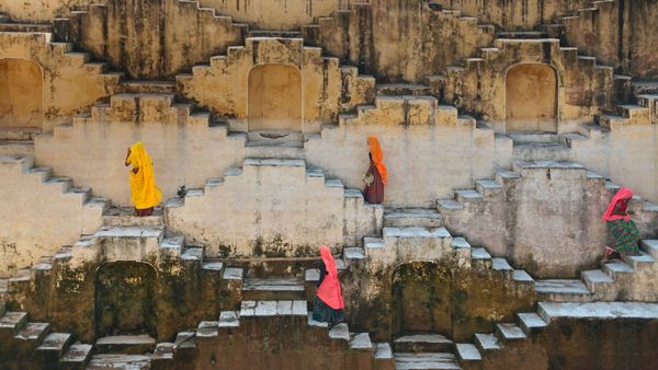 Women climbing a stepwell near Amber Fort in Jaipur, Rajasthan, India