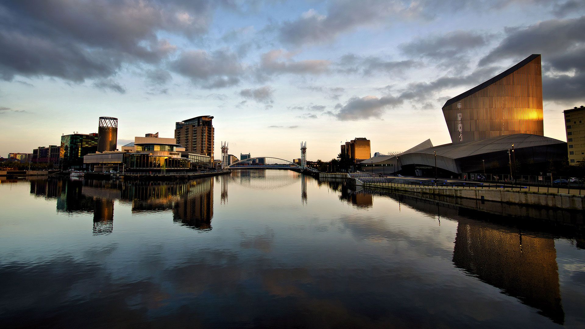 The Lowry Theatre and Imperial War Museum North, with reflections at Salford Quays, Greater Manchester