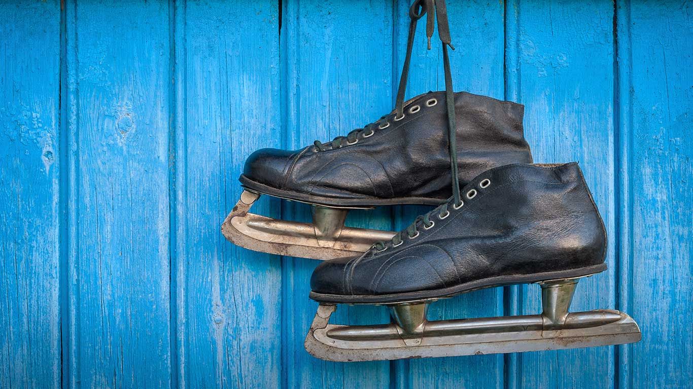 Old hockey skates hanging on a wall
