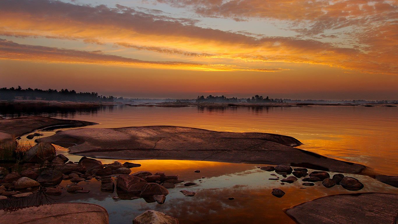 Golden sunrise over the polished granite and water of Georgian Bay, Ontario, Canada