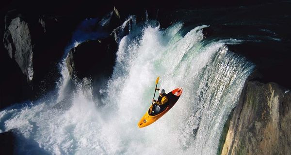 Whitewater kayaking over waterfall