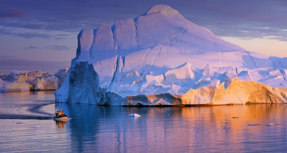 Tour boat and iceberg in Disko Bay, Greenland