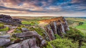 View of the rocky gritstone edge of The Roaches looking over the patchwork landscape, Peak District, Staffordshire. (© George W Johnson/Getty Images)(Bing United Kingdom)