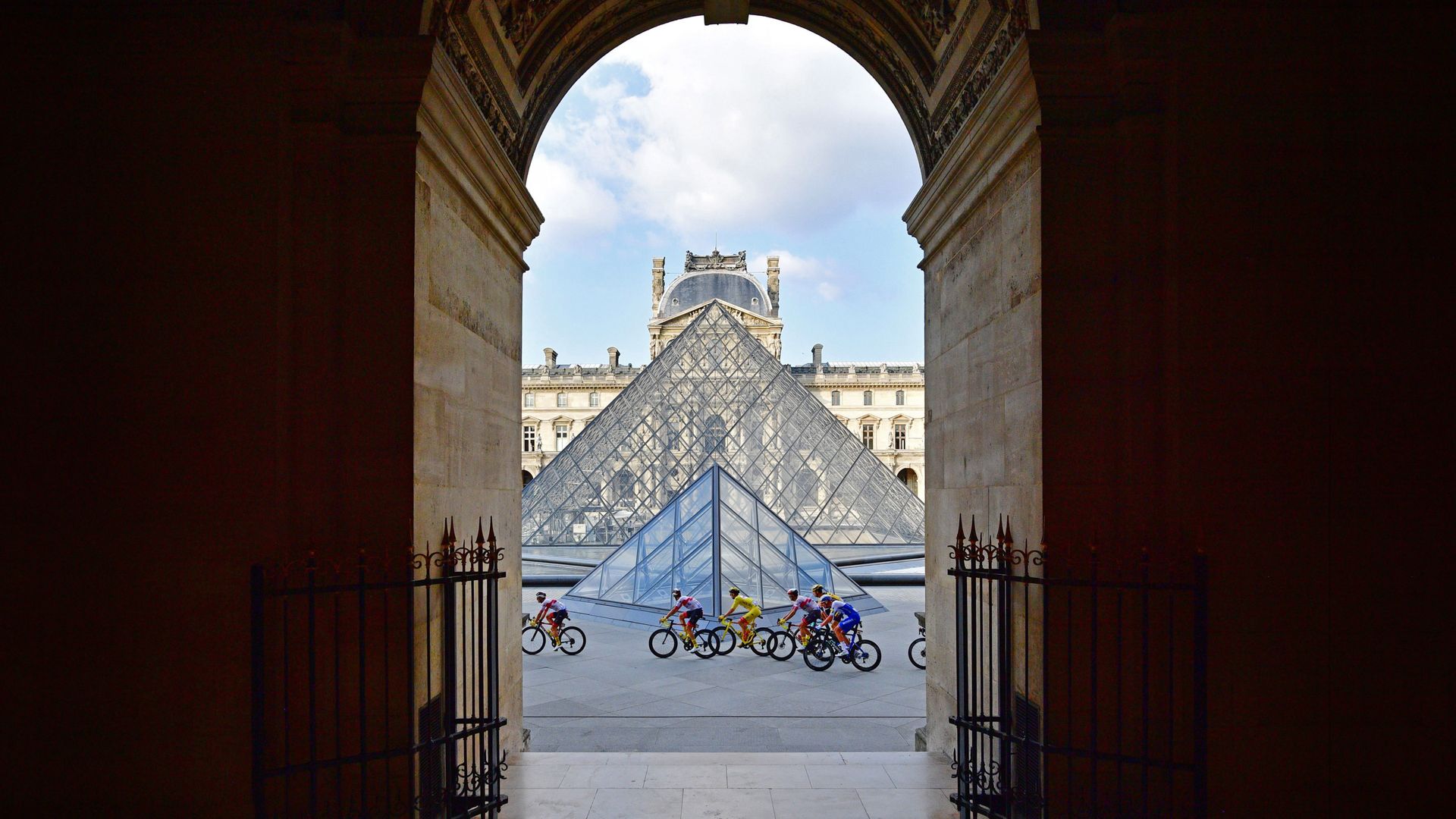 Tour de France riders in front of the Louvre Pyramid and Museum in Paris, France, during the 2020 race