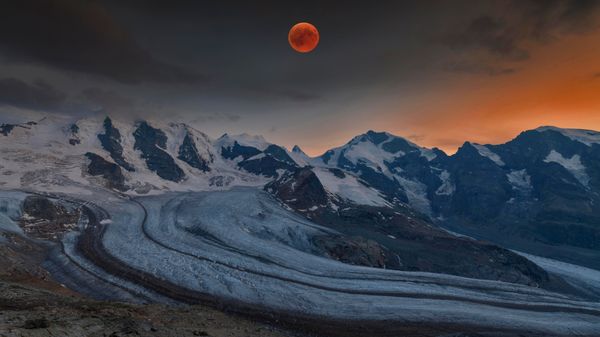Panoramic view of the Bernina Range with blood moon, Eastern Alps, Switzerland