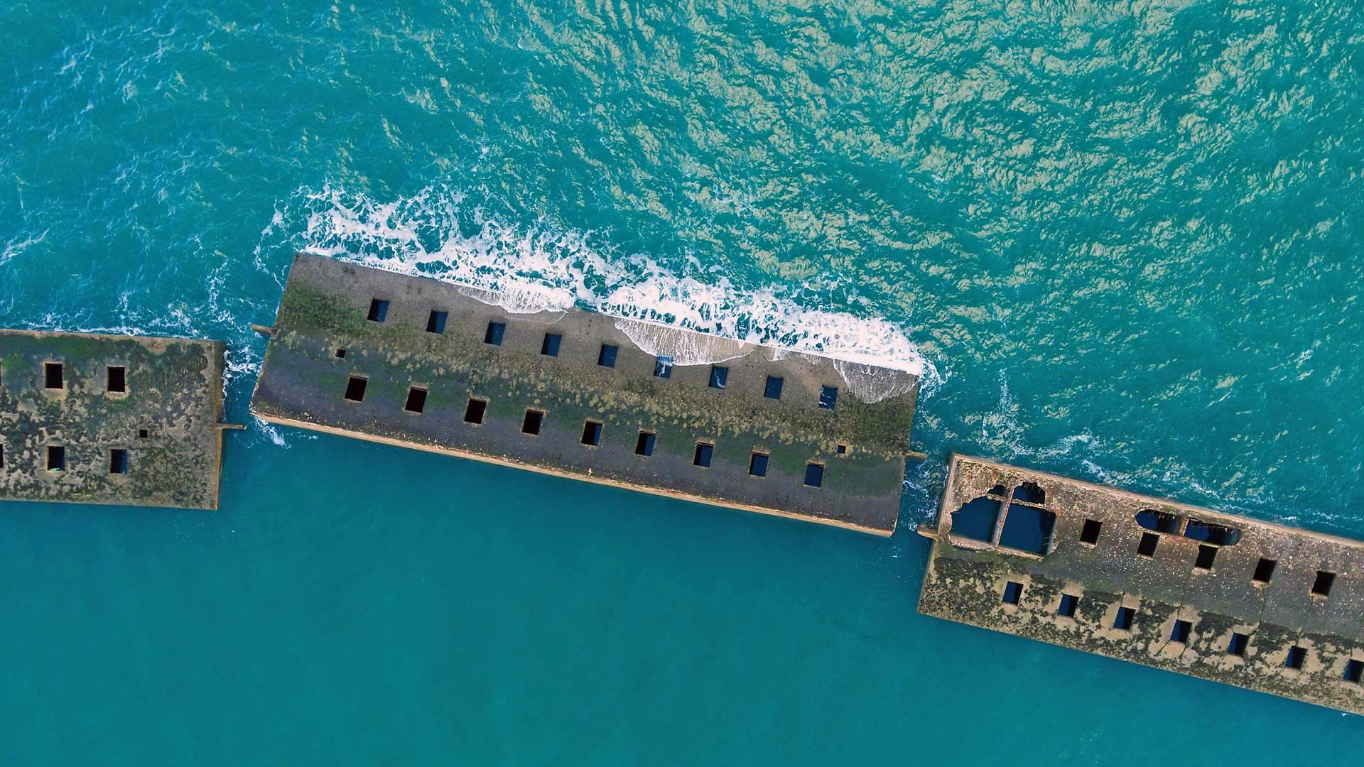 Remains of the Mulberry harbour from the D-Day invasion at Arromanches, Normandy, France