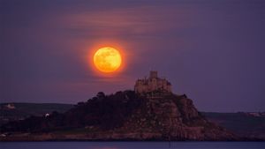 The April full moon, or pink moon, rises over St Michael\'s Mount, Cornwall, England (© Simon Maycock/Alamy Live News)(Bing Australia)