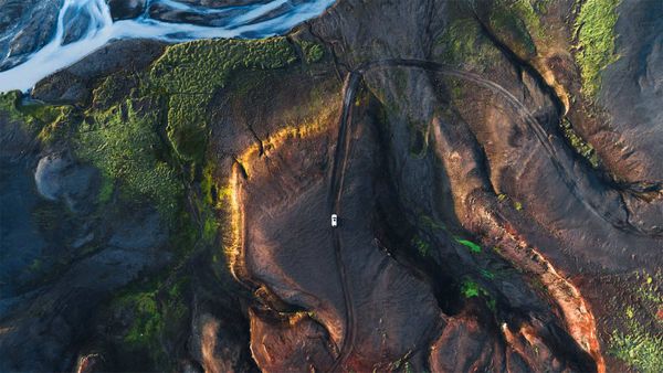 A winding road by a glacial river in the Highlands of Iceland