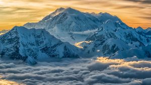 Aerial image of Mount Logan rising above the clouds in Kluane National Park and Reserve, Yukon, Canada (© Robert Postma/plainpicture)(Bing Australia)