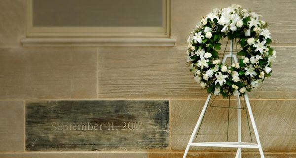 A wreath is placed next to a memorial stone, charred in the 9/11 attack, at the Pentagon in Washington, D.C.