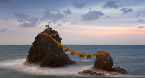 Meoto-Iwa (Wedded Rocks), two rocks considered to be male and female and joined in matrimony by sacred ropes, renewed in a special festival each year, Honshu, Japan