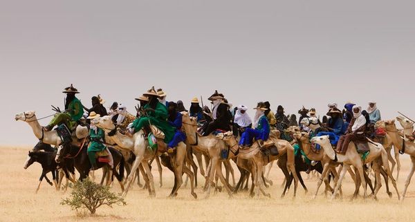 Wodaabe nomads traveling across the desert in Niger, West Africa