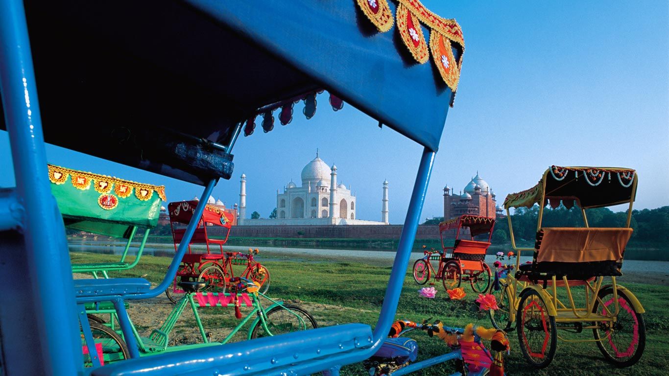 Rickshaws and view of Taj Mahal, Agra, India