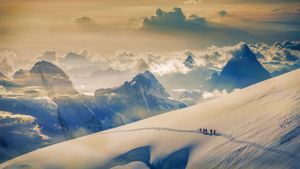 Climbers ascending Jungfrau, in the Bernese Alps, Switzerland (© plainpicture/Cultura/Lost Horizon Images)(Bing New Zealand)