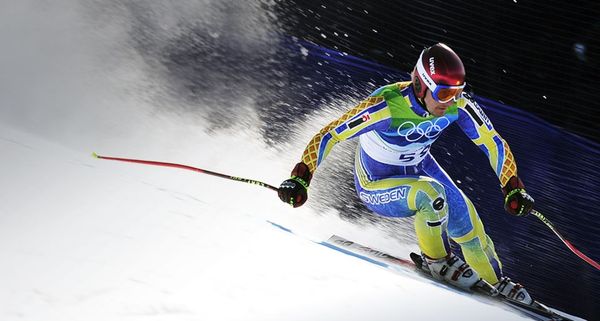 Tajikistan's Andrey Drygin, wearing an old Swedish team ski outfit, clears a gate during the Men's Super-G race at the Vancouver 2010 Winter Olympics on 19 February 2010
