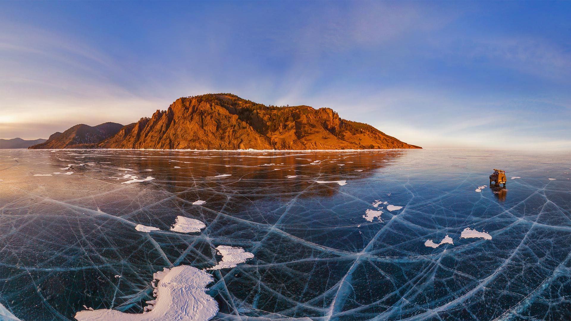 Aerial view of car crossing over the frozen surface of Lake Baikal, Russia
