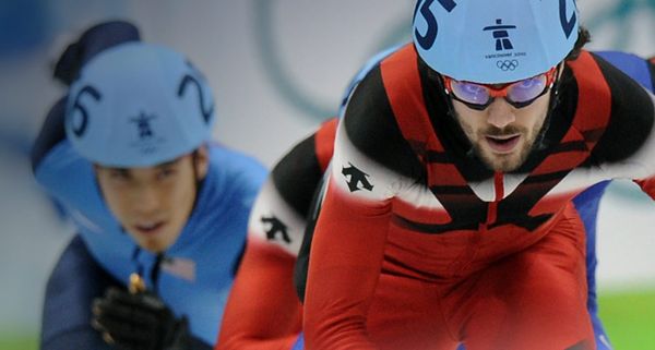 Gold medalist, Canada's Charles Hamelin (R) and Apolo Anton Ohno (L) of the United States n the Men's Short Track 500m final at the 2010 Winter Olympics on February 26, 2010