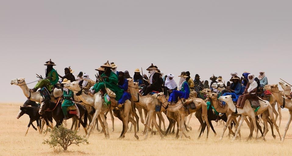 Tribe of Wodaabe nomads traveling across the desert in Niger, West Africa
