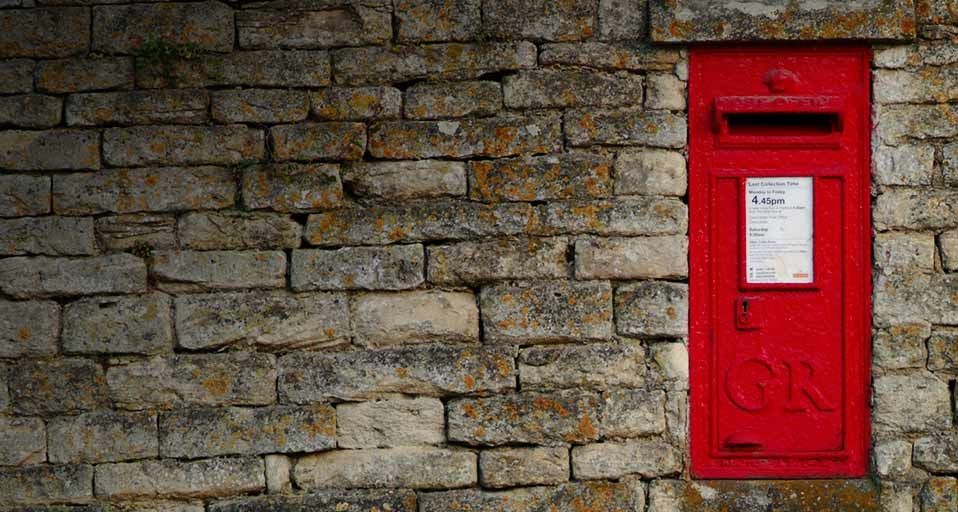 Letterbox mounted in a Cotswold stone wall