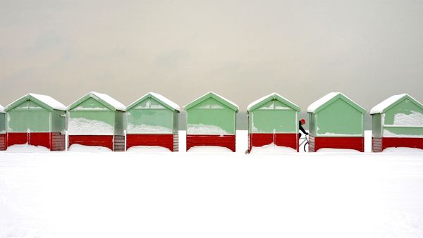 Beach huts covered in snow in Brighton and Hove, East Sussex