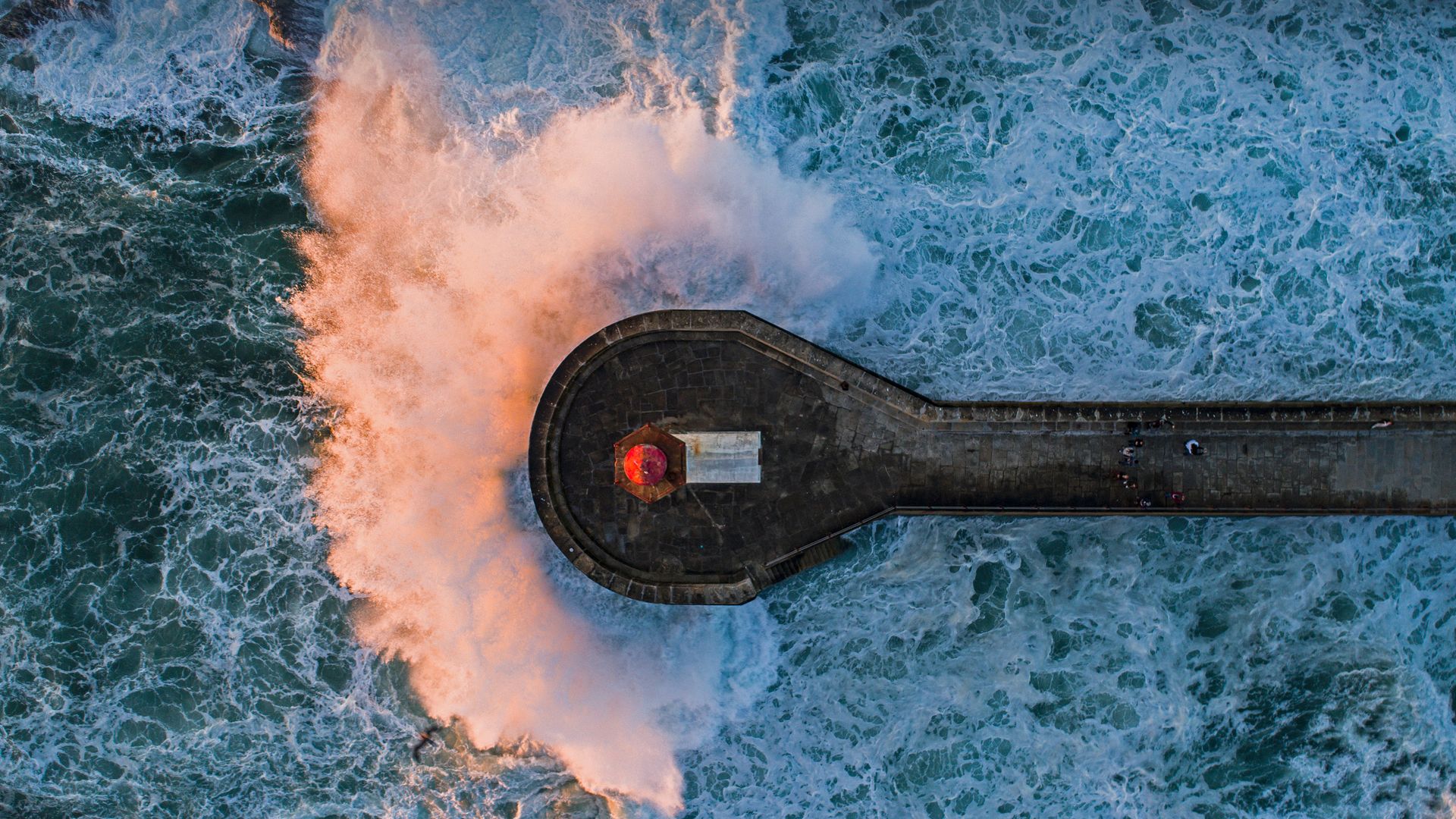 Wave crashing on Farolim de Felgueiras, a lighthouse in Porto, Portugal
