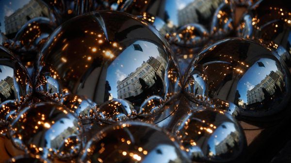 Luxury stores reflected in the Christmas window display of the Fenwick's, London