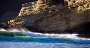 Surfer riding a wave near Pacific City, Oregon, USA (© Gabe Rogel/Aurora Photos) &copy; (Bing Australia)