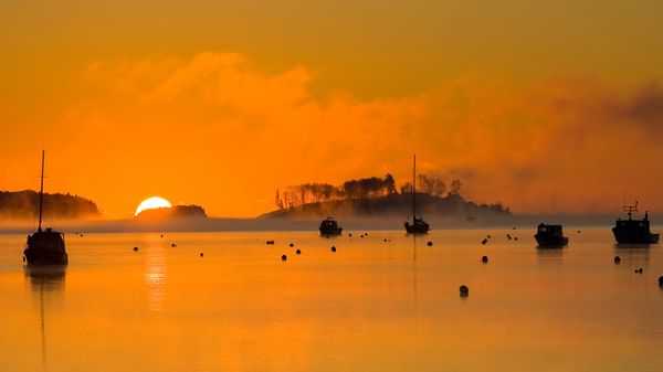 Silhouettes of fishing boats in Mahone Bay, Nova Scotia, Canada