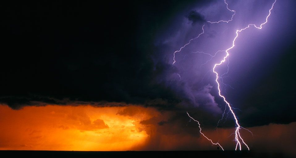 Daytime cloud to ground lightning flashes with three branches to the ground in Texas