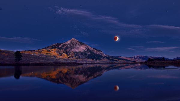 Lunar eclipse above Mount Crested Butte, Colorado, USA