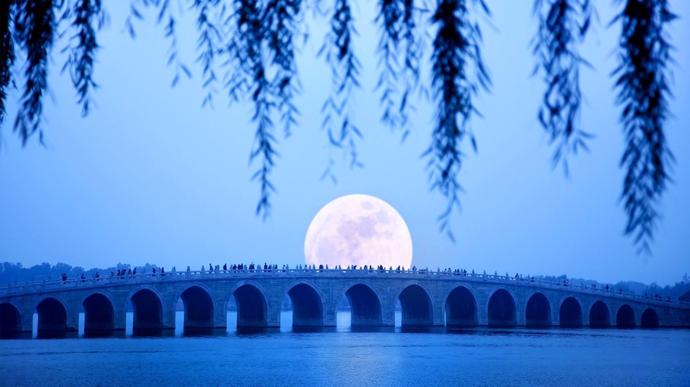 Moonrise over Seventeen Arch Bridge on Kunming Lake at the Summer Palace in Beijing, China