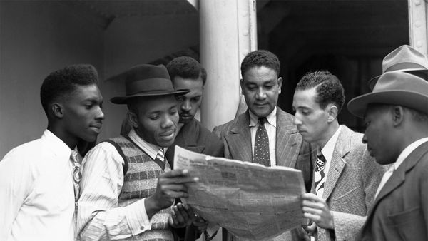 Reading the news aboard the Empire Windrush on arrival at Tilbury, Essex on 22 June 1948
