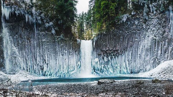 Ice sticking to the columnar basalt walls surrounding Abiqua Falls, Oregon, USA