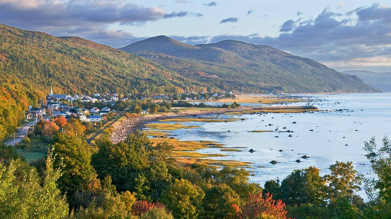 Village nestled between mountains and the St. Lawrence River, Charlevoix, Que.