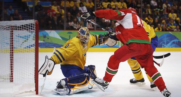 Goalkeeper Jonas Gustavsson of Sweden makes a save against Dmitri Meleshko of Belarus during the Men’s Ice Hockey preliminary game at the Vancouver 2010 Winter Olympics on February 19, 2010
