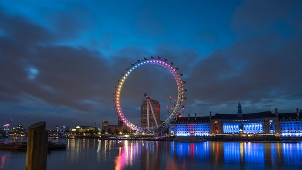 London Eye illuminated at dawn, England