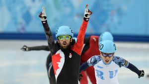 Canada's Charles Hamelin (L) celebrates after winning the gold medal in the Men's Short Track 1500 m Final at the Iceberg Skating Palace during the Sochi Winter Olympics on February 10, 2014  (© Yuri Kadobnov/AFP/Getty Images)(Bing Canada)