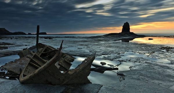 The wreck of the Admiral Van Tromp and Black Nab at sunset, Whitby, Yorkshire, England
