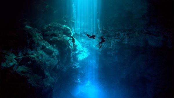 Divers at El Pit Cenote, located in Dos Ojos Natural Park, Quintana Roo, Mexico