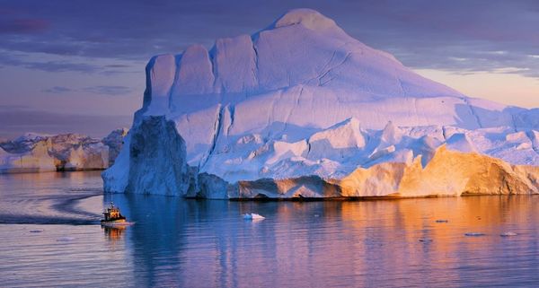 Tour boat and iceberg in Disko Bay, Greenland