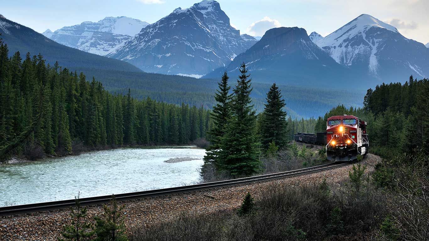 Train passing through Banff National Park, Banff, Alta.